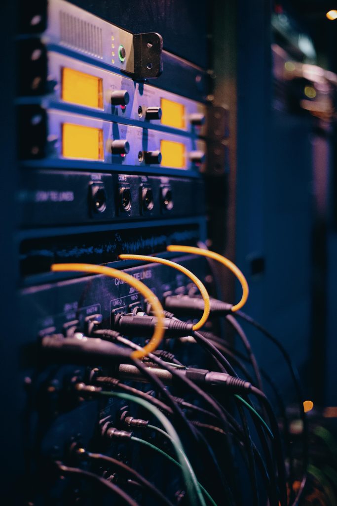 pexels-photo-1054397-1054397 Close-up of network cables and ports in a server rack, showcasing connectivity.