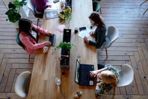 pexels-photo-2041627-2041627 Overhead view of diverse women professionals working in a modern office setting, fostering collaboration and teamwork.